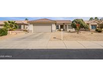 Charming single-story home featuring a desert landscape, two-car garage, and a well-maintained tile roof at 15642 W Arbor Trl, Surprise, AZ 85374