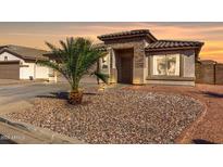 Charming single-story home featuring a desert landscape, tile roof, and cozy, welcoming entrance at 16035 N 159Th Dr, Surprise, AZ 85374
