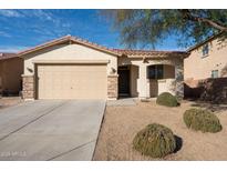 Charming single-story home featuring a two-car garage and low maintenance desert landscaping at 17350 W Adams St, Goodyear, AZ 85338