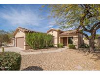 Charming single-story home with xeriscaping, covered porch, and two car garage at 17560 W East Wind Ave, Goodyear, AZ 85338