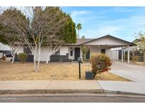 Charming single-story home featuring desert landscaping and a convenient covered carport at 2593 E Commonwealth Cir, Chandler, AZ 85225