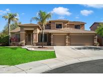 Charming two-story home with a well-manicured lawn, a three-car garage, and beautiful palm trees at 3410 E Pageant Pl, Gilbert, AZ 85297