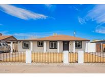 Charming single-story home with a well-maintained front yard and secure fence at 3436 E Pierce St, Phoenix, AZ 85008