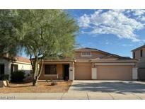 Charming single-story home with a three-car garage and well-manicured front yard at 36452 W Velazquez Dr, Maricopa, AZ 85138