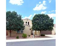 Charming two-story home with a well-manicured front yard and a private two-car garage at 3687 E Blue Spruce Ln, Gilbert, AZ 85298
