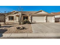 Charming single-story home featuring a three-car garage, tile roof, and low maintenance desert landscaping at 3756 E Camden Ave, San Tan Valley, AZ 85140