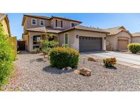 Charming two-story home featuring a well-manicured, low-maintenance yard and inviting curb appeal at 3935 E Blue Spruce Ln, Gilbert, AZ 85298