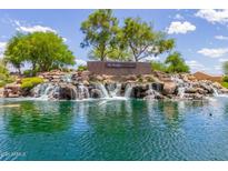 Picturesque water feature at The Bridges in Gilbert, Arizona, with waterfalls cascading into a serene lake at 3935 E Blue Spruce Ln, Gilbert, AZ 85298