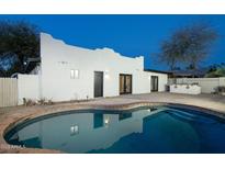 Inviting pool area with a white exterior home, perfect for relaxation and outdoor enjoyment at 4731 E Monte Vista Rd, Phoenix, AZ 85008