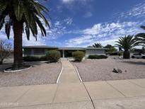 Charming home featuring a well-manicured front yard with desert landscaping and a walkway to the entrance at 6132 E Decatur St, Mesa, AZ 85205