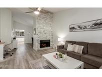 Inviting living room featuring a stone fireplace and modern furnishings creating a cozy atmosphere at 6885 E Cochise Rd # 235, Paradise Valley, AZ 85253