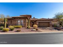 Inviting desert home featuring stone accents, tile roof, and a charming xeriscaped front yard at 8041 E Teton Cir, Mesa, AZ 85207