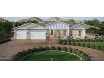 Charming home features a three-car garage and a beautifully landscaped front yard with mountain views at 9318 E Cloudview Ave, Gold Canyon, AZ 85118