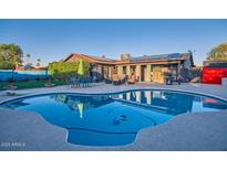 Inviting backyard pool with patio furniture and lush landscaping for outdoor relaxation and entertaining at 15034 N 54Th St, Scottsdale, AZ 85254