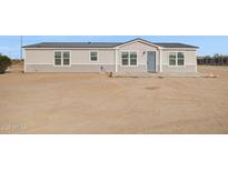 Inviting single story home with a neutral color palette, gray trim and matching entry door at 1811 N Brower Ln, Maricopa, AZ 85139