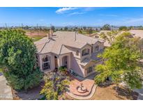 Desirable neighborhood, with a meticulously maintained front yard, complemented by verdant trees and colorful landscaping at 1831 W San Angelo St, Gilbert, AZ 85233