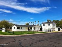 Charming updated house with a well-manicured lawn and black decorative fence at 2946 E Flower St, Phoenix, AZ 85016