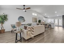 Bright, open-concept living room featuring modern furnishings, wood floors, and a ceiling fan at 3050 S Cascade Pl, Chandler, AZ 85248