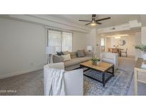 Bright living room featuring a ceiling fan, recessed lighting, and neutral colors creating a warm and inviting atmosphere at 3420 W Danbury Dr # C216, Phoenix, AZ 85053