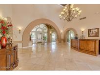 Elegant lobby showcasing travertine floors, arched entryways, and a chandelier at 4200 N Miller Rd # 220, Scottsdale, AZ 85251