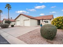 Charming single-story home with a two-car garage and a well-maintained, desert-landscaped front yard at 542 S Higley Rd # 83, Mesa, AZ 85206