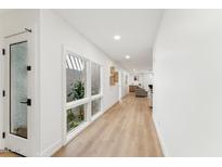 Bright hallway with light wood floors, white walls and natural light from a window at 8088 E Via Del Valle --, Scottsdale, AZ 85258