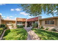 Charming home featuring a well-maintained lawn and a cozy walkway to the front entrance at 1320 E Bethany Home Rd # 24, Phoenix, AZ 85014