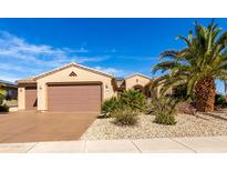 Charming single-story home with a well-manicured yard and a two-car garage at 16528 W Isleta Ct, Surprise, AZ 85387