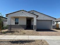 Charming single-story home with a two-car garage and low maintenance desert landscaping at 17683 W Odeum Ln, Goodyear, AZ 85338