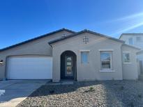 Charming single-Gathering home with a two-car garage, desert landscaping, and a welcoming front porch at 19333 W Valle Vista Way, Litchfield Park, AZ 85340