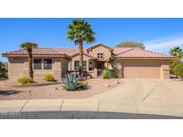 Charming single-story home featuring a tile roof, desert landscaping, and a welcoming front entrance at 19824 N Valencia Ct, Surprise, AZ 85374