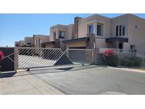 Elegant stucco townhomes feature stone accents and a secure gated entrance, providing privacy and curb appeal at 2241 E Pinchot Ave # B3, Phoenix, AZ 85016