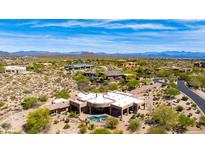 Stunning aerial view of luxury home with private pool, desert landscaping and mountain views on a sunny day at 24548 N 121St Pl, Scottsdale, AZ 85255