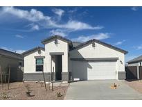 Charming single-story home featuring a two-car garage, neutral paint, and a well-manicured front yard at 25430 W Graham Trl, Buckeye, AZ 85326