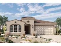 Charming single-story home featuring a desert landscape, arched windows, and a spacious two-car garage at 32970 N 131St Dr, Peoria, AZ 85383