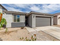 Charming single-story home with a two-car garage, desert landscaping, and a welcoming front entrance at 36284 W San Clemente Ave, Maricopa, AZ 85138