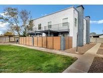 Two-story home featuring a fenced yard, a chimney, and a small upper deck at 4142 N 11Th St # 10, Phoenix, AZ 85014
