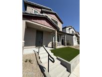 Inviting front entrance with a dark front door, desert landscaping, and concrete steps leading to the covered porch at 470 S Soho Ln # 1, Chandler, AZ 85225