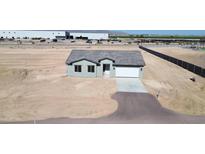 Single-story home featuring a gray stucco exterior, a gray roof, and an attached two-car garage at 6250 S Dean Rd, Buckeye, AZ 85326