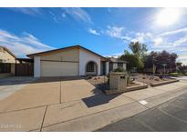 Charming single-story home featuring a two car garage and desert landscaping at 6331 W Eva St, Glendale, AZ 85302
