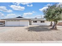Charming single-story home featuring a white exterior, gravel landscaping, and an attached garage at 7745 N 33Rd Ave, Phoenix, AZ 85051