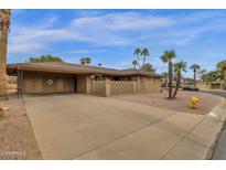Inviting home with a spacious covered carport and desert landscaping at 915 S Saranac Ave, Mesa, AZ 85208