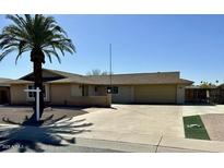 Single Gathering home featuring desert landscaping and mature palm tree at 9929 W Burns Dr, Sun City, AZ 85351