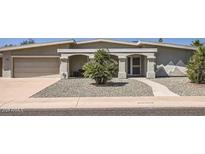 Charming single-story home with arched entryway and desert landscaping at 10822 W Mimosa Dr, Sun City, AZ 85373