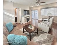 Inviting living room with a plush sofa, a ceiling fan, and lots of natural light at 111 S Greenfield Rd -- # 462, Mesa, AZ 85206