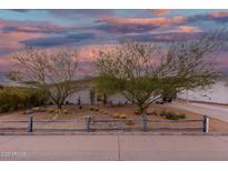 Charming home featuring desert landscaping with barrel cactus and mature mesquite trees at 12220 N Escobar Way, Phoenix, AZ 85022