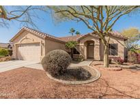 Inviting single-story home with a well-maintained front yard, desert landscaping, and a two-car garage at 13208 W Desert Rock Dr, Surprise, AZ 85374