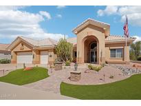 Charming single-story home with a well-manicured desert landscape, beautiful walkway, and a welcoming arched entryway at 14110 W Robertson Dr, Sun City West, AZ 85375