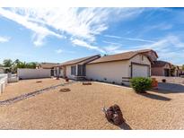 Inviting single-Gathering house featuring desert landscaping, and a two car garage at 14957 W Bottle Tree Ave, Surprise, AZ 85374