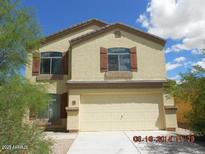 Charming two-story home featuring neutral-colored stucco and a two-car garage with a concrete driveway at 17936 N Lettere Cir, Maricopa, AZ 85138